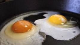These are eggs frying in a pan.