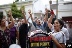 People gather in front of the Presidential House in Guatemala City, demanding the resignation of Guatemala's President Otto Perez Molina, Aug. 23, 2015.