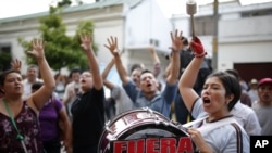 People gather in front of the Presidential House in Guatemala City, demanding the resignation of Guatemala's President Otto Perez Molina, Aug. 23, 2015.