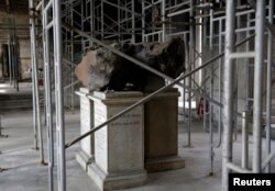 A meteorite on exhibit at the entrance of Brazil's National Museum stills stands at its original place after a fire destroyed the building in 2018, in Rio de Janeiro, Feb. 12, 2019.