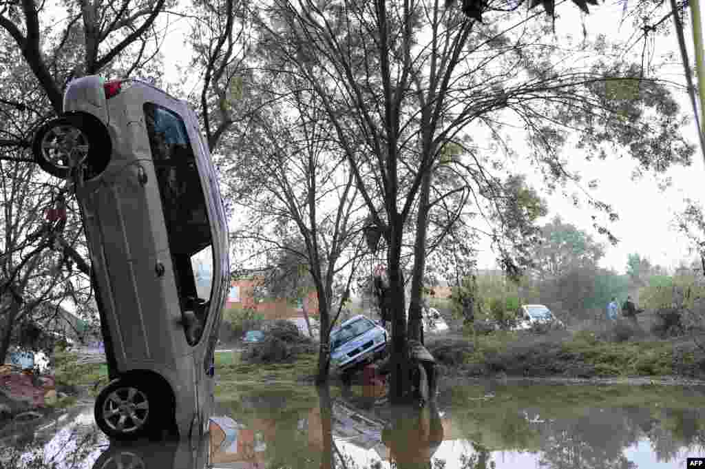 A car is seen in an upright position after the overnight flash floods due to heavy rains in Grabels near Montpellier, France. 