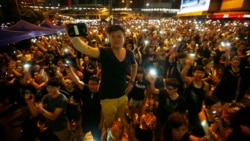 Protesters turn on their mobile phone flashlights as they block an area outside the government headquarters building in Hong Kong Oct. 1, 2014. 