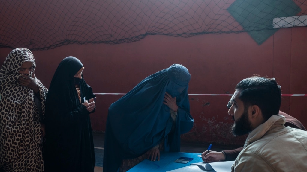 A woman registers to receive money from the WFP in Kabul on Nov. 17, 2021. (AP/Petros Giannakouris)