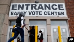 FILE - Voters arrive to vote early at the Franklin County Board of Elections, Oct. 31, 2018, in Columbus, Ohio. 