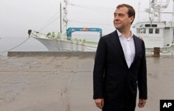 FILE - Russian Prime Minister Dmitry Medvedev visits a berth in the Yuzhno-Kurilsk bay in the town of Yuzhno-Kurilsk, on the Kunashir Island of the Kuril Islands, Russia, July 3, 2012.