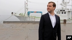 FILE - Russian Prime Minister Dmitry Medvedev visits a berth in the Yuzhno-Kurilsk bay in the town of Yuzhno-Kurilsk, on the Kunashir Island of the Kuril Islands, Russia, July 3, 2012.