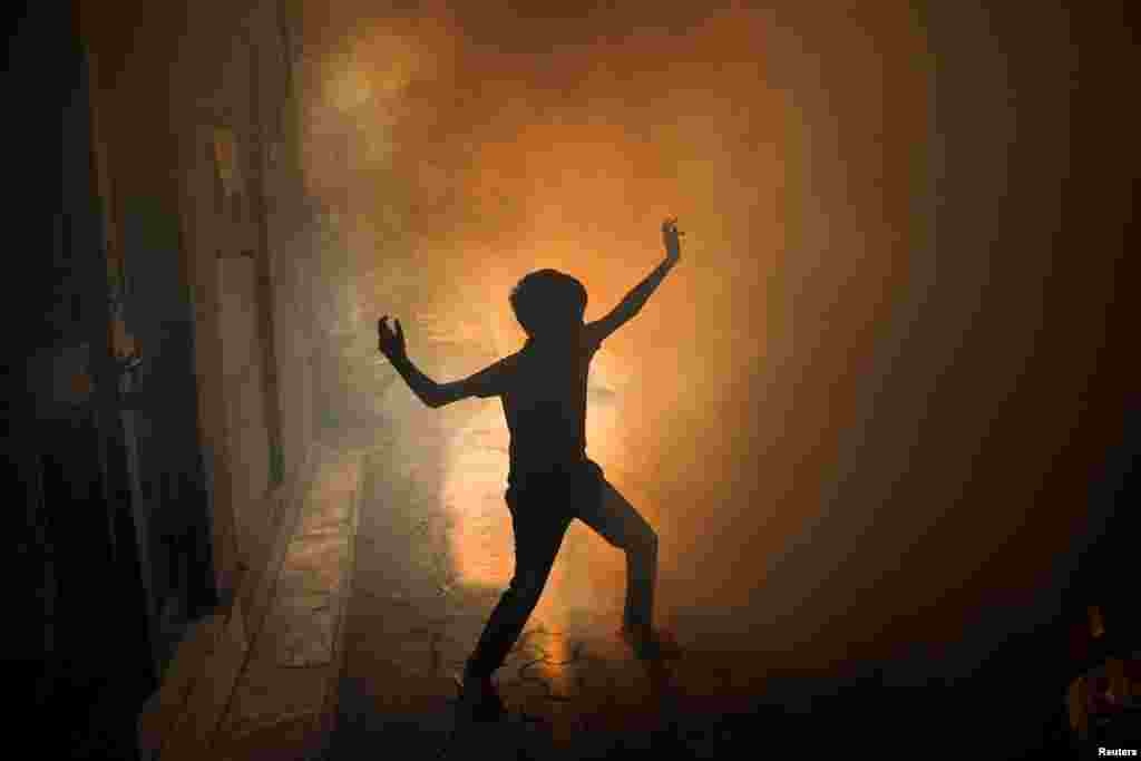 A child plays during a fumigation drive conducted by the municipal corporation as dengue cases surge in New Delhi, India.