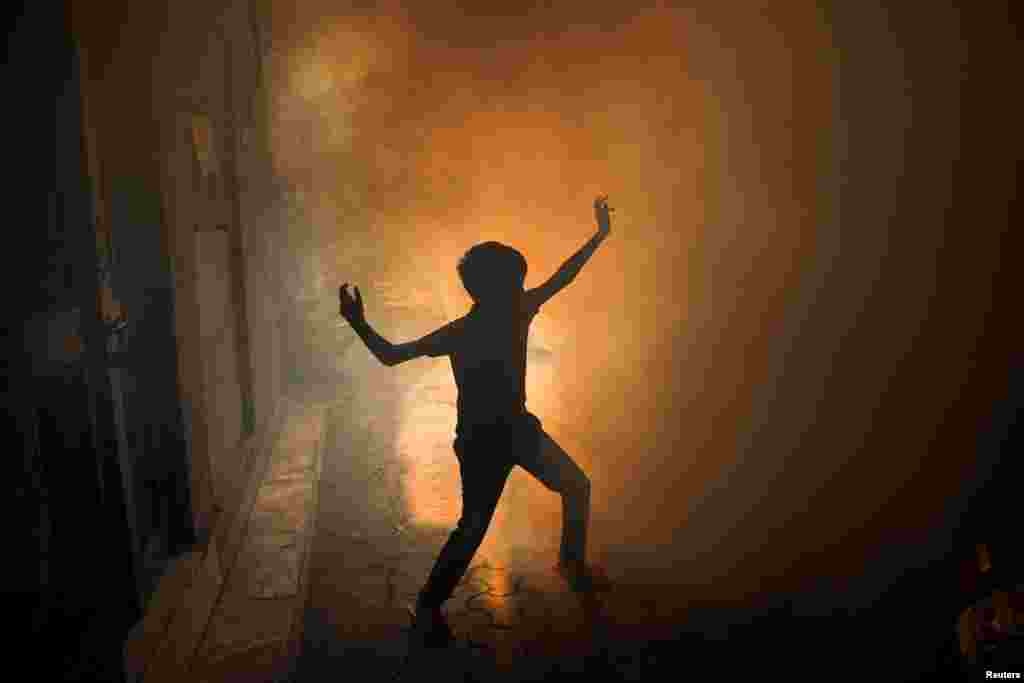 A child plays during a fumigation drive carried out by the municipal corporation as dengue case numbers rise in New Delhi, India.