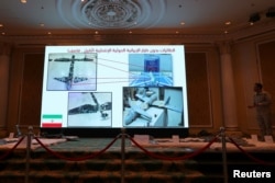 FILE - Saudi-led coalition spokesman, Colonel Turki al-Malki, displays Iran-aligned Houthi drones, brought down April 11 over Jizan and Abha, during a news conference in Khobar, Saudi Arabia, April 16, 2018.