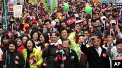 Demonstrators shout slogans and march in protest against the polices of Taiwan's China-friendly President Ma Ying-jeou in Taipei, Taiwan, January 13, 2013. 