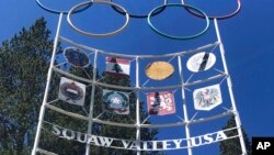FILE - The Olympic rings stand atop a sign at the entrance to the Squaw Valley Ski Resort in Olympic Valley, Calif., on July 8, 2020. 