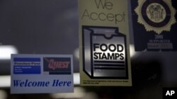 FILE - A supermarket displays stickers indicating it accepts food stamps in West New York, N.J., Jan. 12, 2015.