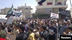 Demonstrators pray during a protest against Syria's President Bashar Al-Assad, in Sermeen, near Idlib, Syria, August 17, 2012.