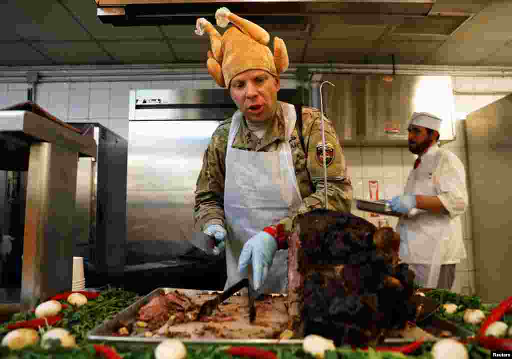 A U.S. Army soldier serves Thanksgiving meal to his comrades at the Resolute Support headquarters in Kabul, Afghanistan.