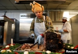 A U.S. Army soldier serves Thanksgiving meal to his comrades at the Resolute Support headquarters in Kabul, Afghanistan November 22, 2018.