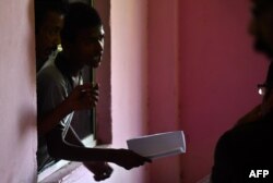 A man, whose names is left off of the National Register of Citizens (NRC) draft, stands in a line to collect forms to file appeals at a NRC Sewa Kendra (NSK) in Guwahati, Aug. 11, 2018.