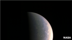 NASA's Juno spacecraft captured this view as it closed in on Jupiter's north pole, about two hours before closest approach on Aug. 27, 2016.