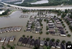 Homes are surrounded by floodwaters from Tropical Storm Harvey, Aug. 29, 2017, in Spring, Texas.