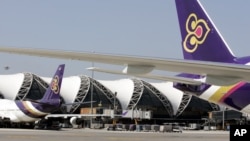 FILE - Thai Airways passenger planes park at the ramp of Bangkok's Suvarnabhumi airport.