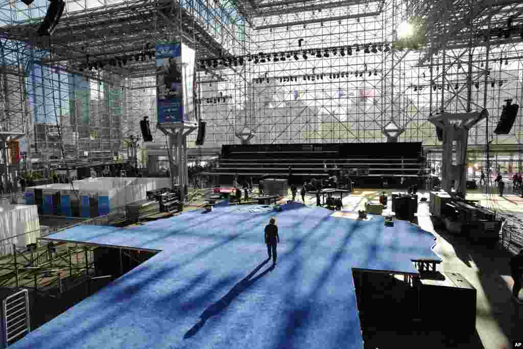 Workers prepare a blue carpeted stage for Democratic presidential candidate Hillary Clinton&#39;s election night venue inside the Jacob Javits Convention Center in New York City. The city is preparing for an election night like few others in its history, with both candidates planning &quot;victory&quot; parties about a mile apart in midtown Manhattan.