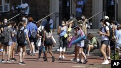University of North Carolina students wait outside of Woolen Gym on the Chapel Hill, N.C., campus as they wait to enter for a fitness class Monday, Aug. 17, 2020. (Julia Wall/The News & Observer via AP).