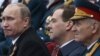 Russian President Putin and Prime Minister Medvedev, center, watch Victory Day Parade, Moscow, May 9, 2012.