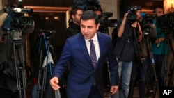 FILE - Selahattin Demirtas, co-leader of the pro-Kurdish Peace and Democracy Party, arrives for a meeting with representatives of minorities living in Turkey at a hotel in central Istanbul ahead of elections, Oct. 28, 2015.