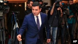 FILE - Selahattin Demirtas, co-leader of the pro-Kurdish Peace and Democracy Party, arrives for a meeting with representatives of minorities living in Turkey at a hotel in central Istanbul ahead of elections, Oct. 28, 2015.