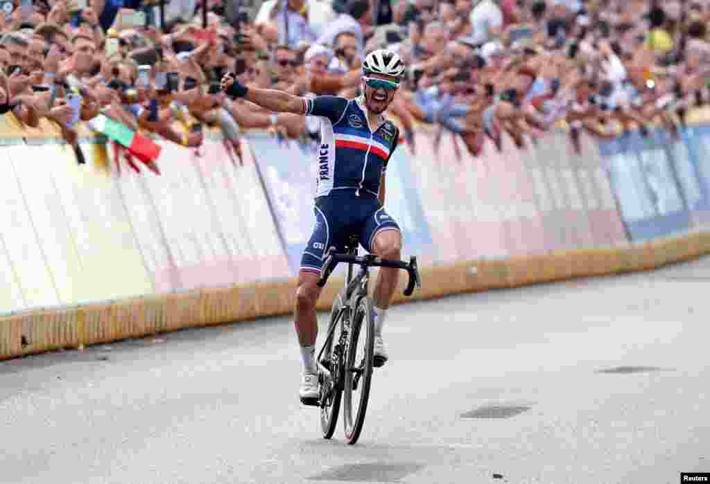 Julian Alaphilippe fo France celebrates as he crosses the finish line to win the cycling road race during&nbsp;the Flanders 2021 UCI Road World Championships in Leuven, Belgium.