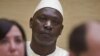  Thomas Lubanga (C) na bosambisami bwa ye na Cour pénale internationale, na La Haye, le 14 mars 2012.