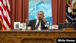 President Barack Obama talks with President Hassan Rouhani of Iran during a phone call in the Oval Office, Sept. 27, 2013.