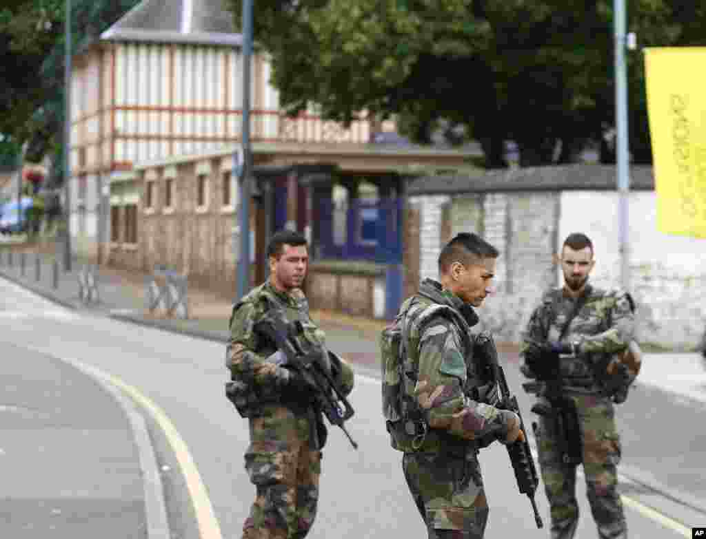 French soldiers stand guard as they prevent the access to the scene of an attack in Saint Etienne du Rouvray, Normandy, France on July 26, 2016. 