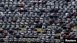 FILE - New Ford trucks are seen at a parking lot of the Ford factory in Sao Bernardo do Campo, Brazil, Feb. 12, 2015. 