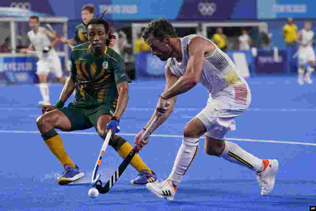 Belgium&#39;s Sebastien Dockier (9) drives up the pitch against South Africa&#39;s Tyson Dlungwana (3) during a Men&#39;s field hockey match at the 2020 Summer Olympics, Tuesday, July 27, 2021, in Tokyo, Japan. (AP Photo/John Minchillo)