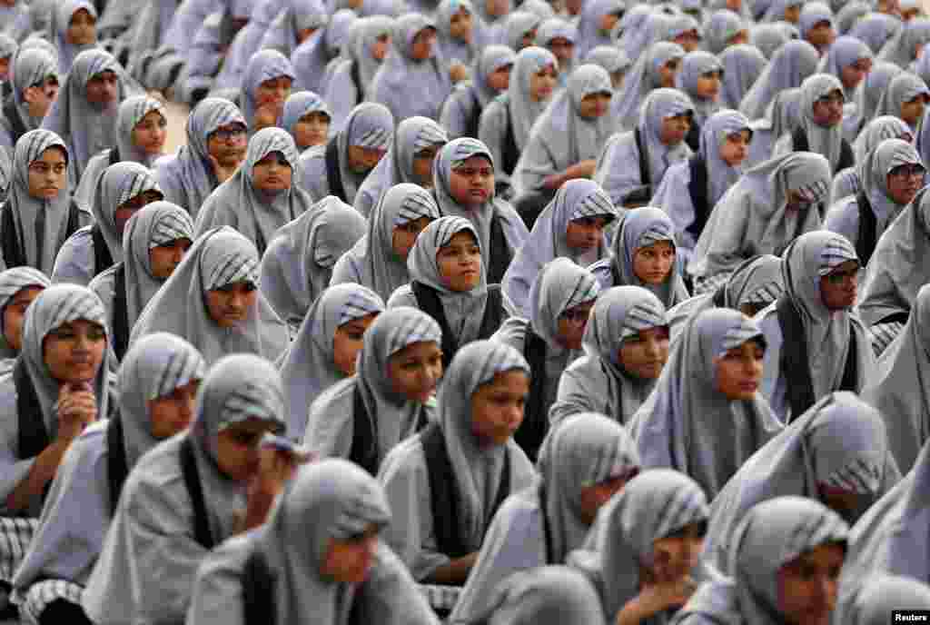 School girls listen to their teacher (not pictured) during a lecture on the Article 370, a special constitutional status for Kashmir which was scrapped by the Indian government last month, to mark Prime Minister Narendra Modi&#39;s birthday at a school in Ahmedabad, India.