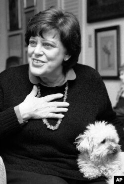 Actress Kaye Ballard gestures during an interview in her New York apartment, Feb. 27, 1984, while her dog, Big Shirley, sits on her lap.