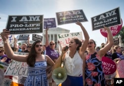 Anti-abortion activists demonstrate in front of the Supreme Court in Washington, June 27, 2016.
