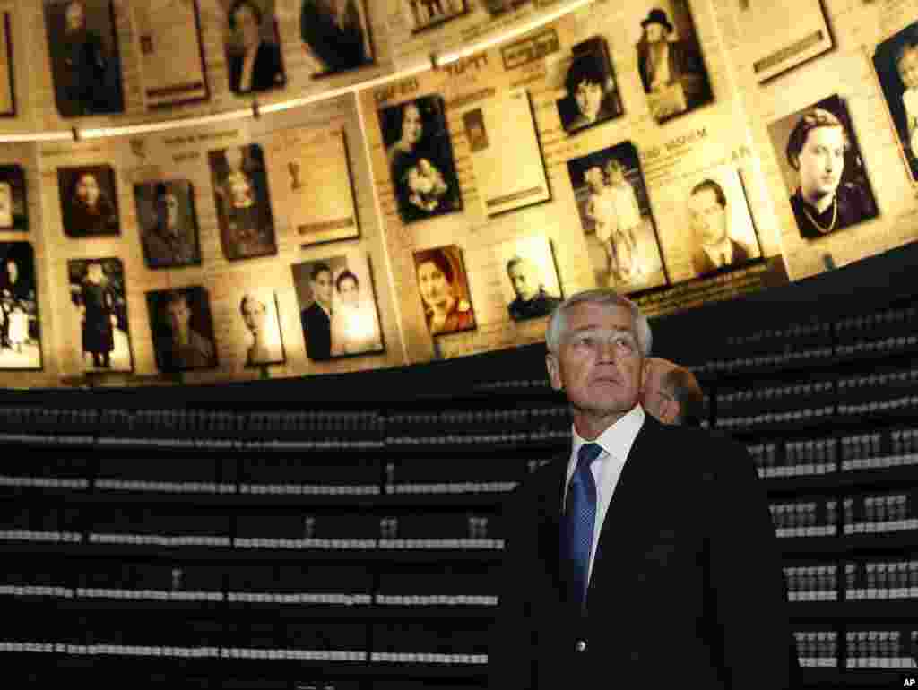 U.S. Secretary of Defense Chuck Hagel looks at pictures of Jews killed in the Holocaust during a visit to the Hall of Names at Yad Vashem's Holocaust History Museum in Jerusalem, Israel, April 21, 2013. 