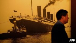 FILE - A visitor walks past a big portrait of the Titanic at the Titanic Experience and Priceless Artifact Exhibition in Shanghai, Aug. 11, 2004. 