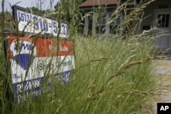 FILE -- Overgrown lawns are frowned upon in the United States and are thought to lower property values. Photo taken in Cinncinati, Ohio.