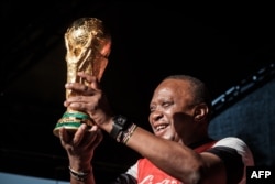 Kenya's President Uhuru Kenyatta holds the FIFA World Cup Trophy during its World Tour at the State House in Nairobi, Feb. 26, 2018.