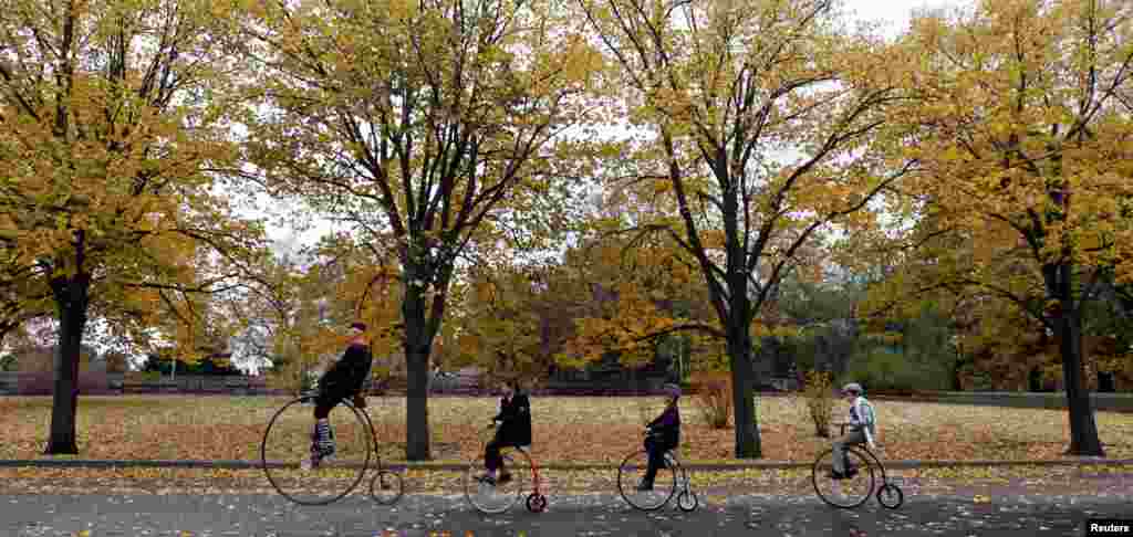 Participants wearing historical costumes ride their high-wheel bicycles during the annual penny farthing race in Prague, Czech Republic, Nov. 5, 2016.