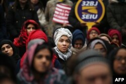 FILE - Local Muslims and immigration activists participate in a prayer and rally against President Donald Trump's immigration policies, Jan. 27, 2017 in New York City.