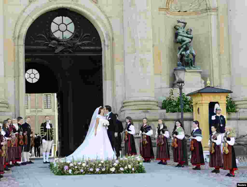 Sweden's Princess Madeleine kisses U.S.-British banker Christopher O'Neill outside the royal church after their wedding ceremony in the royal castle in Stockholm. June 8, 2013.