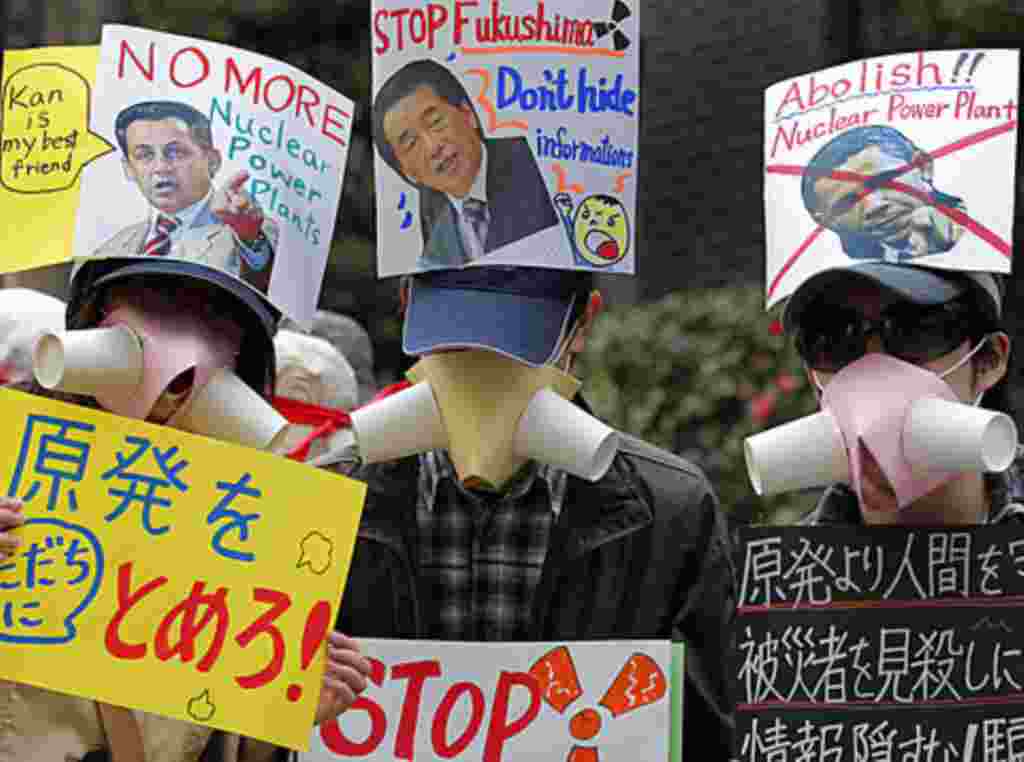 Protesters hold placards condemning the use of nuclear power at a rally in Tokyo, Sunday, April 10, 2011, after a devastating earthquake and tsunami crippled the Fukushima Daiichi nuclear complex in northeastern Japan last month