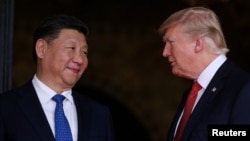 FILE - U.S. President Donald Trump welcomes Chinese President Xi Jinping at Mar-a-Lago state in Palm Beach, Fla., April 6, 2017. 