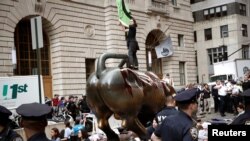 Climate change activists protest at the Wall Street Bull in Lower Manhattan during Extinction Rebellion protests in New York City, New York, U.S., October 7, 2019.