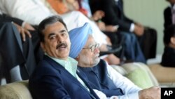Pakistan's Prime Minister Yusuf Raza Gilani sits with his Indian counterpart Manmohan Singh as they watch the ICC Cricket World Cup semi-final match between India and Pakistan in Mohali March 30, 2011. The prime ministers of nuclear-armed foes India and P