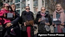 From left, Yuan Shanshan, Liu Ermin, Wang Qiaoling and Li Wenzu pose for the media after they shaved their heads to protest the detention of their husbands in Beijing on Dec. 17, 2018.