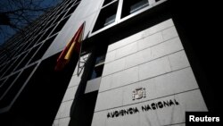 FILE - A Spanish flag waves at the entrance of Spain's High Court in central Madrid, Spain, April 18, 2016. Spanish authorities this week issued arrest warrants for several Russians - some reputedly associates of President Putin - suspected of having ties